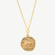 Gold necklace with a zodiac pendant on a white background