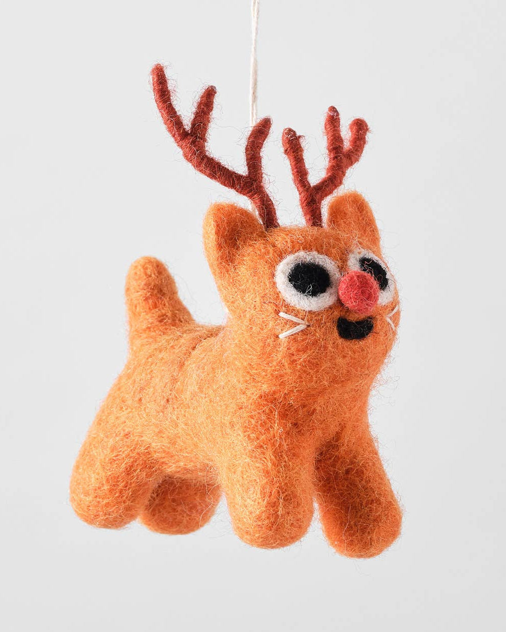 Plush reindeer toy with antlers on a white background.
