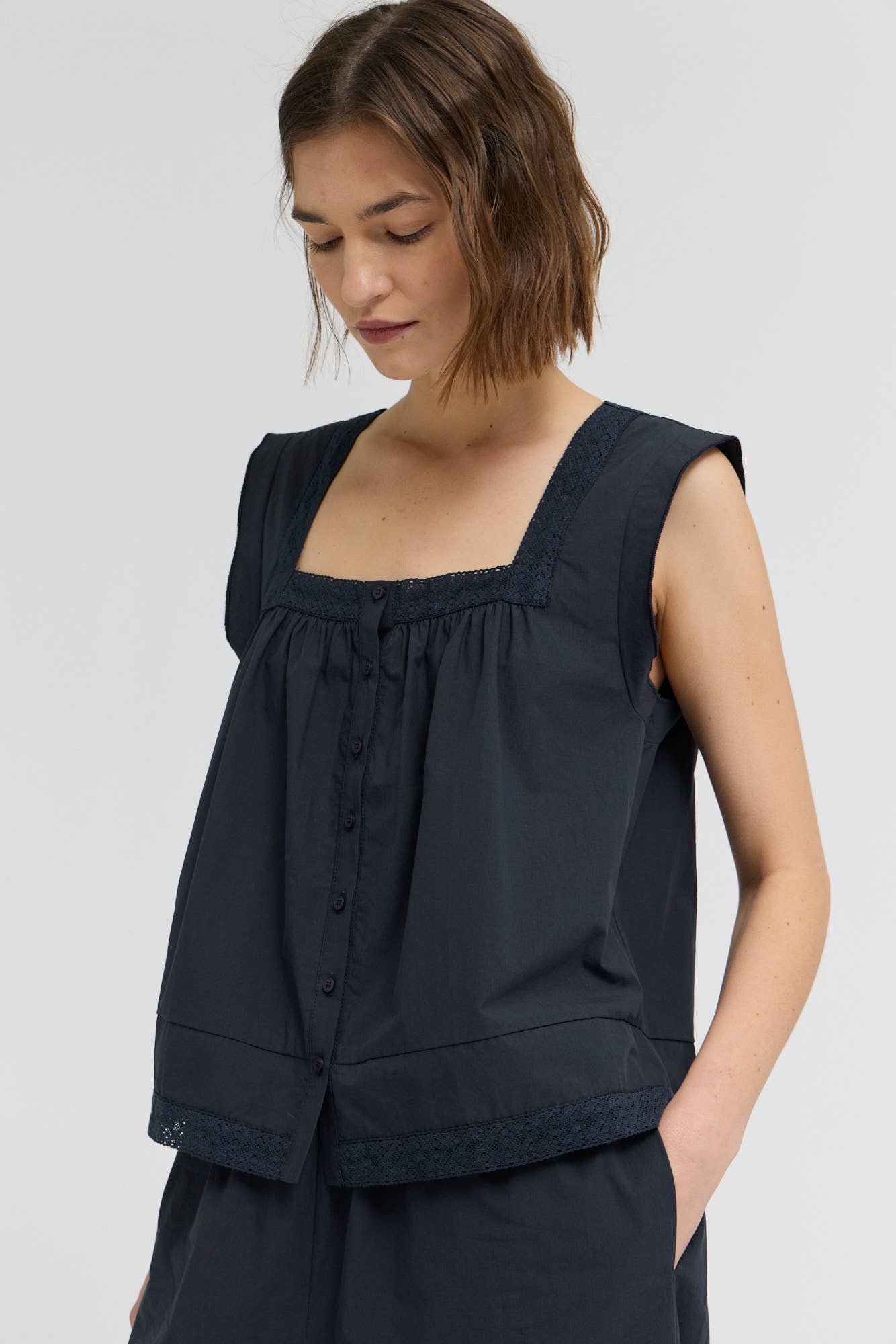 Eyelet Trim Detailed Sleeveless Top