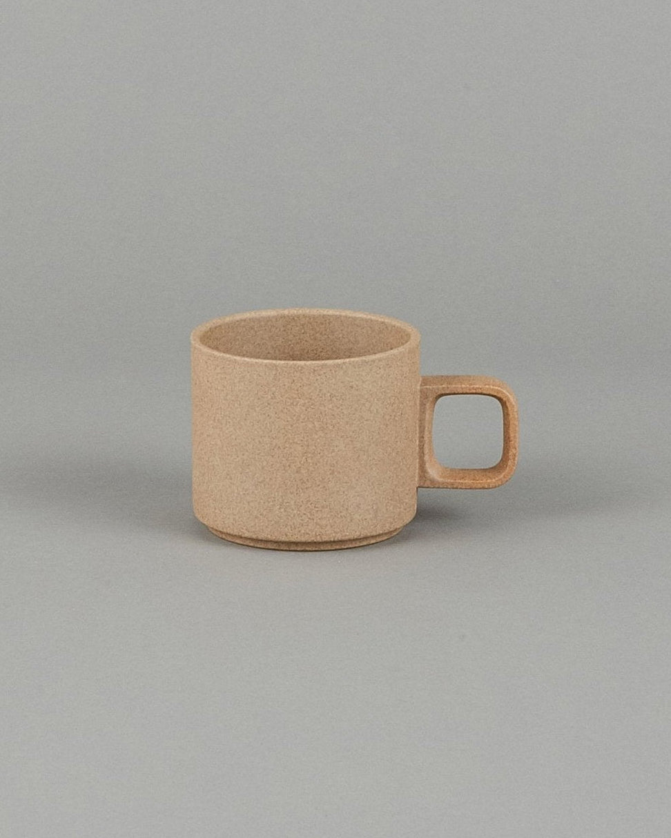 Beige ceramic mug on a gray background